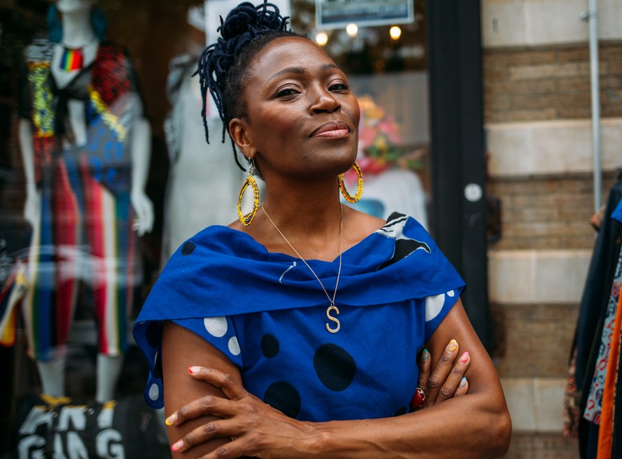 A small business owner standing in their shop